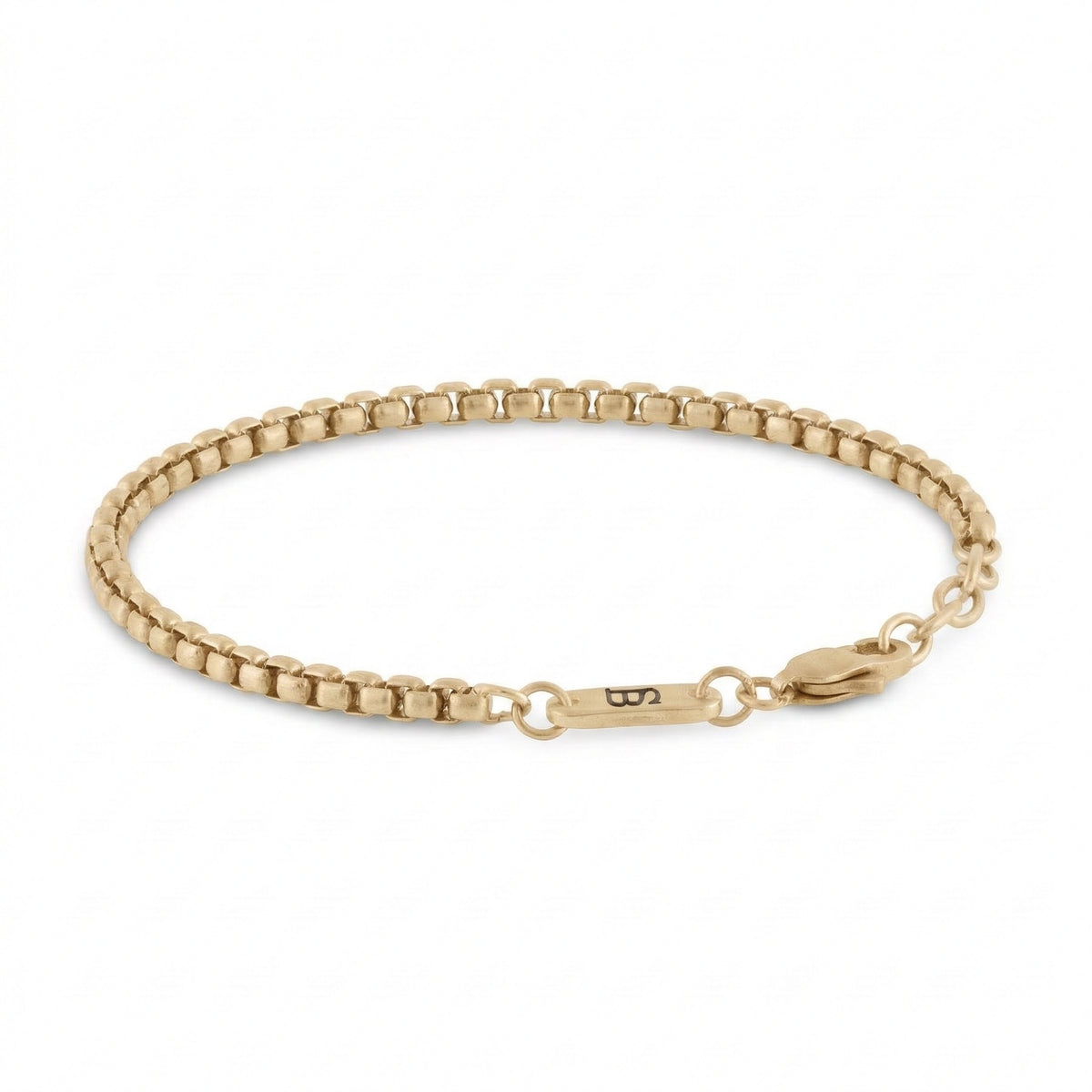 Gold stainless steel men's bracelet with box chain links and plated 18K gold clasp with small engraved tag detail on a white background