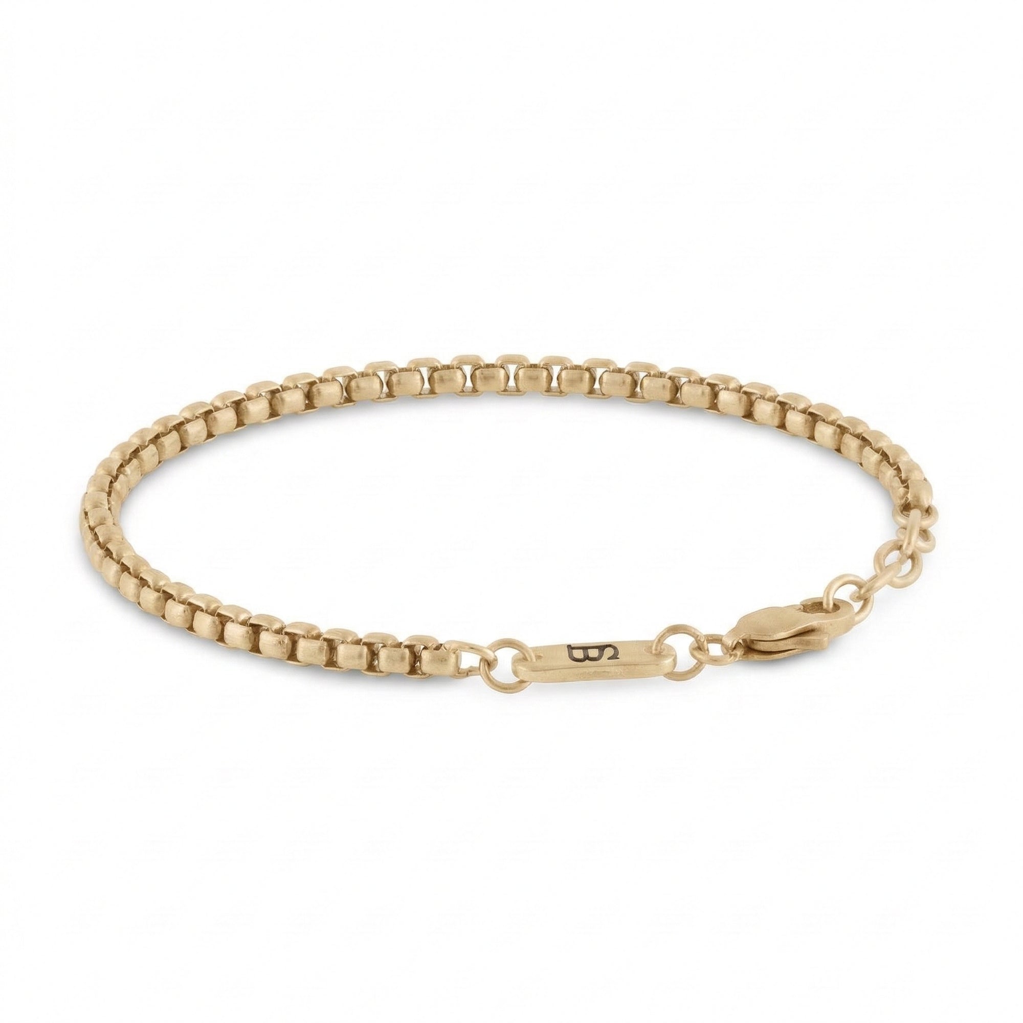 Gold stainless steel men's bracelet with box chain links and plated 18K gold clasp with small engraved tag detail on a white background