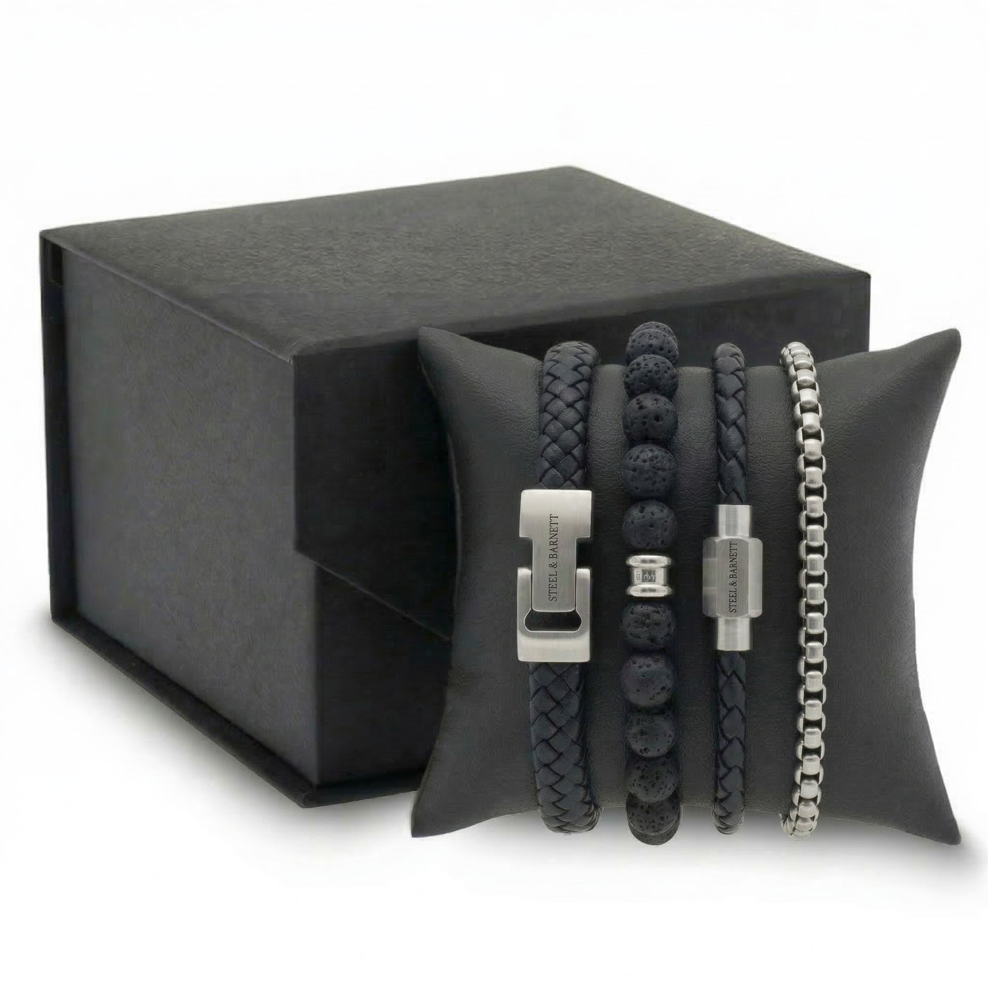 Black braided leather and beaded men's bracelet set with stainless steel clasps displayed on cushion with gift box