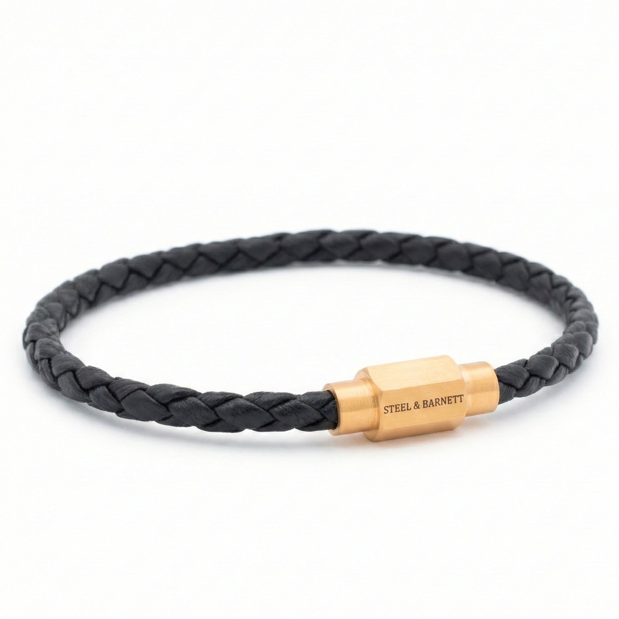 Black braided leather men’s bracelet with plated 18K gold clasp on a white background