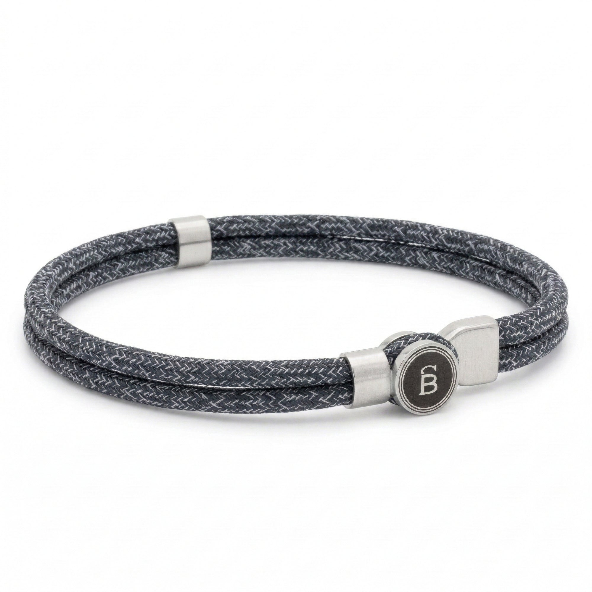 Grey braided rope men’s bracelet with brushed stainless steel magnetic clasp and round logo detail on a white background