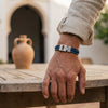 man wearing a blue bracelet in a andalusian setting