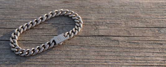 cuban curb link bracelet on wooden surface