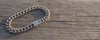 cuban curb link bracelet on wooden surface