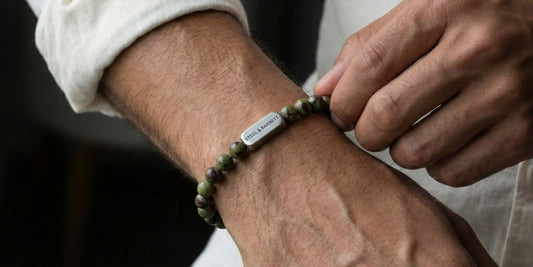 Green natural stone men’s bracelet with round beads and a silver tone metal accent, shown worn on the wrist