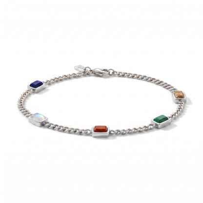 A silver chain bracelet featuring five rectangular gemstone charms in different colors (blue, white, red, green, brown) set in polished silver tiles, displayed on a clean white background.