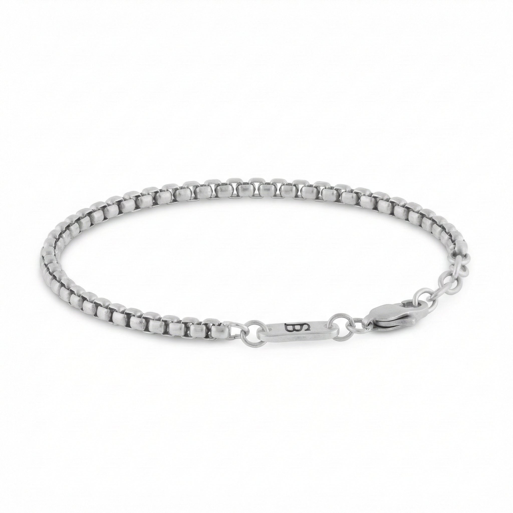 Silver stainless steel men's bracelet with box chain links and lobster clasp with small engraved tag detail on a white background