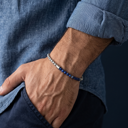 Silver men's beaded bracelet with blue gemstone beads and stainless steel chain detail shown on wrist