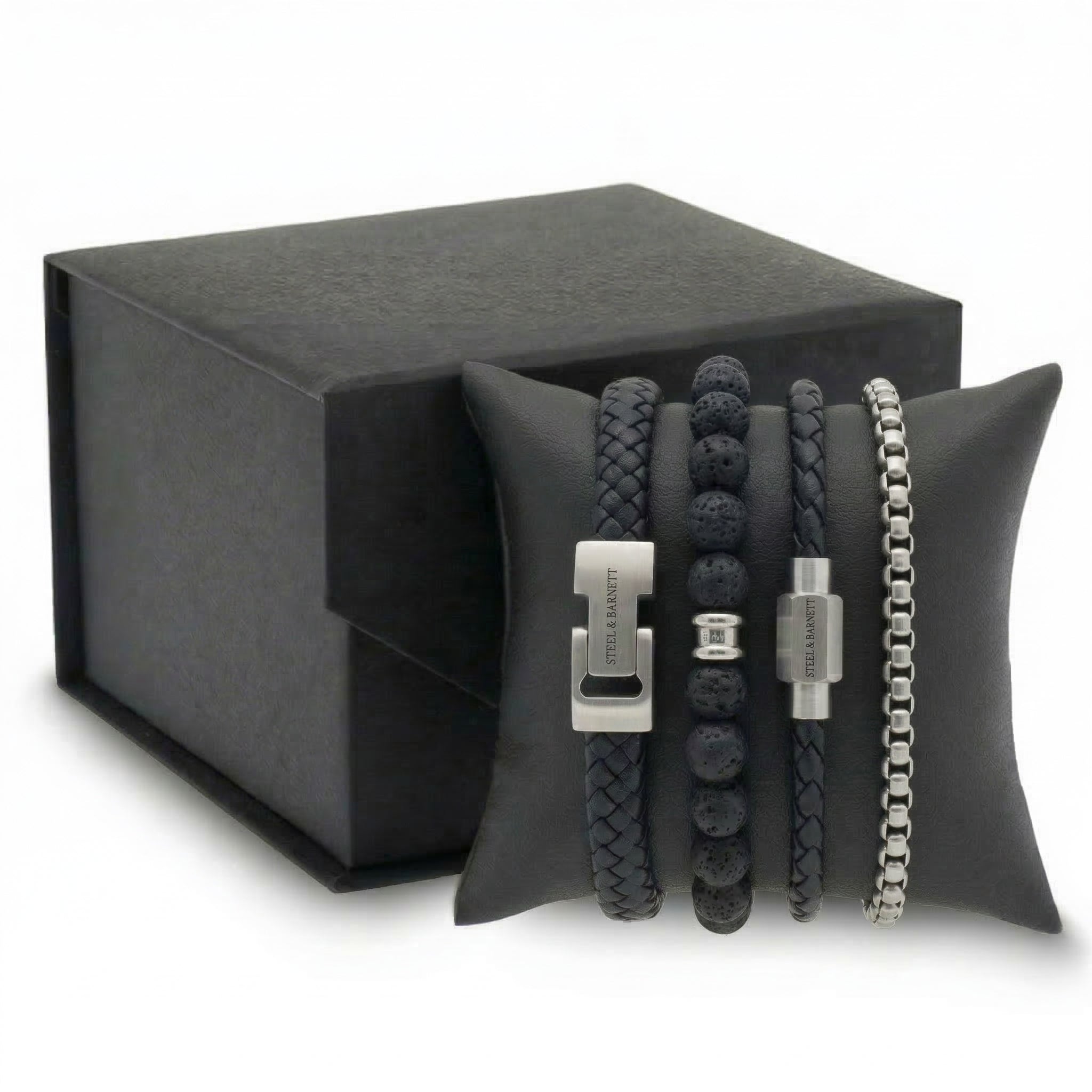 Black braided leather and beaded men's bracelet set with stainless steel clasps displayed on cushion with gift box