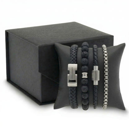 Black braided leather and beaded men's bracelet set with stainless steel clasps displayed on cushion with gift box