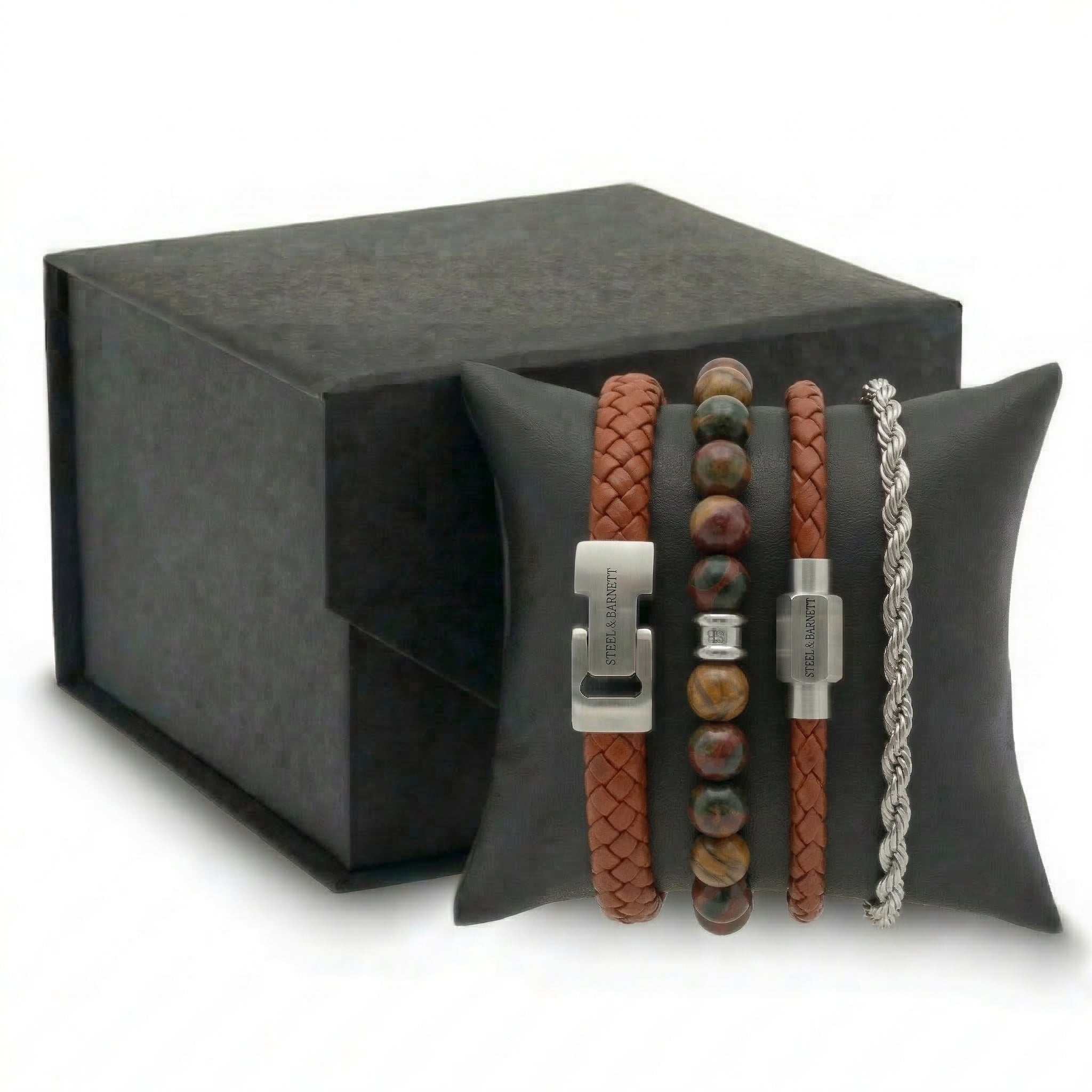 Brown braided leather and beaded men's bracelet set with stainless steel clasps displayed on cushion with gift box