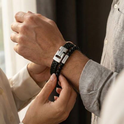 Black braided leather men's bracelet with brushed stainless steel clasp and matching beaded bracelet adjusted on wrist in a lifestyle shot