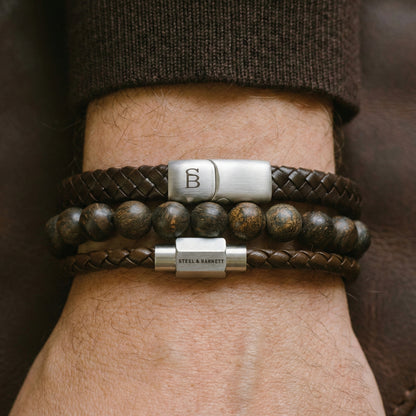 Brown leather men’s bracelet stack with braided bands and natural stone beads featuring brushed stainless steel magnetic clasps worn on wrist