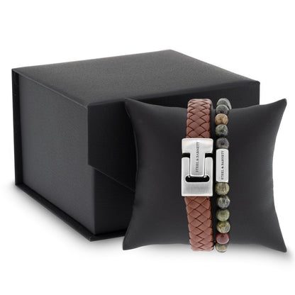 Brown braided leather men’s bracelet with brushed stainless steel clasp and green toned natural stone beads displayed on a black cushion next to a gift box