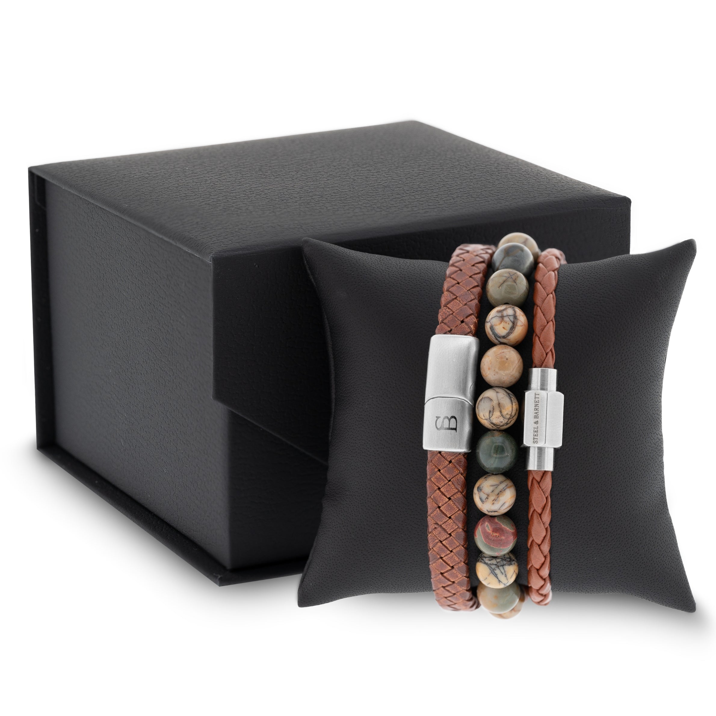 Cognac braided leather men’s bracelet set with multicolor natural stone bead bracelet and brushed stainless steel clasps displayed on a black cushion with gift box