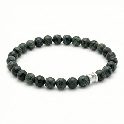 Dark green kambaba stone men's bracelet with smooth round beads and stainless steel accent on a white background