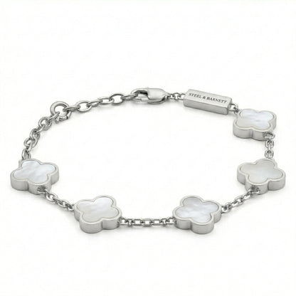 Silver toned men’s bracelet with white clover shaped inlays in stainless steel links and lobster clasp on a white background