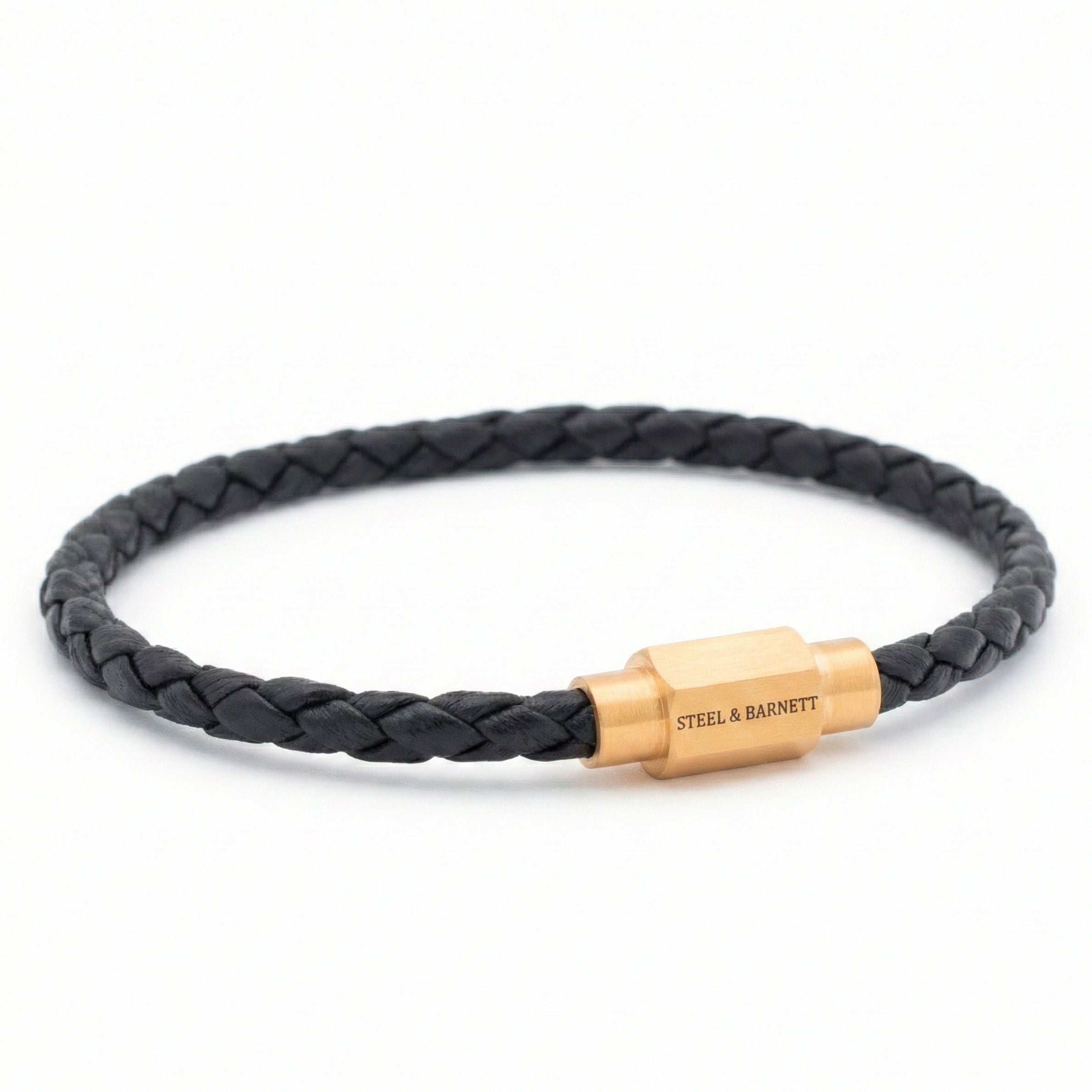 Black braided leather men’s bracelet with plated 18K gold clasp on a white background