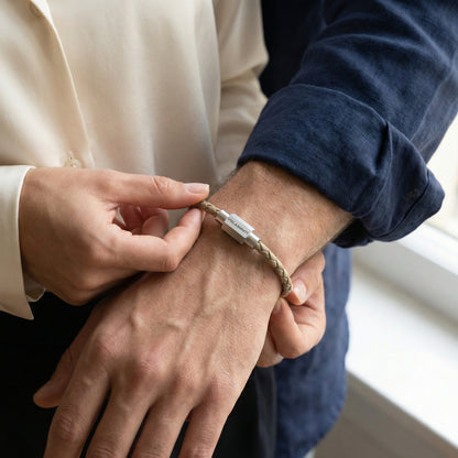 Beige braided leather men’s bracelet with brushed stainless steel magnetic clasp worn on wrist in lifestyle setting