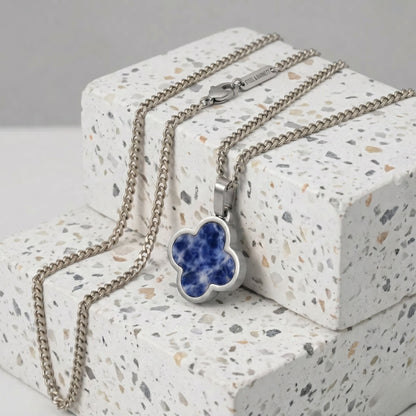 Necklace with a blue sodalite pendant on a textured surface