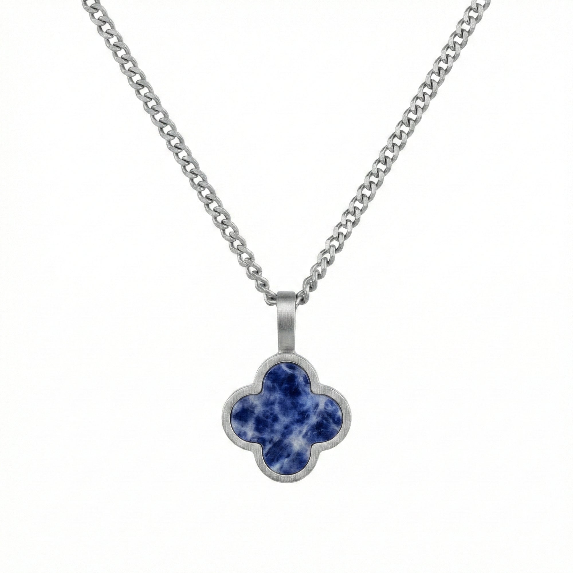 Silver necklace with a blue clover-shaped sodalite pendant on a white background