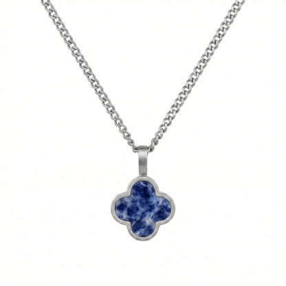 Silver necklace with a blue clover-shaped sodalite pendant on a white background
