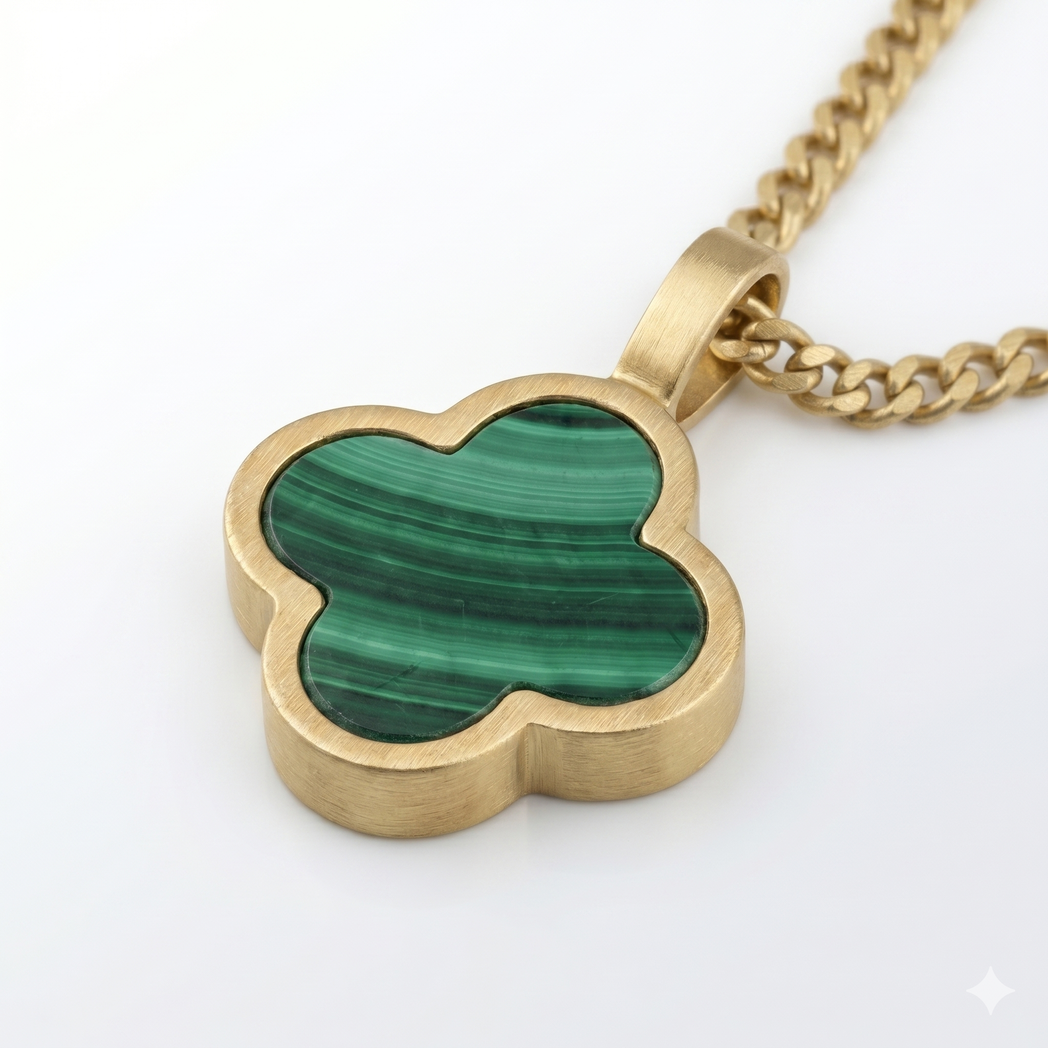 Gold necklace with a green Malachite clover-shaped pendant on a white background