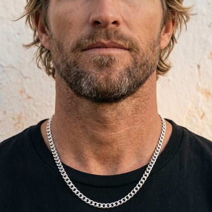 Silver stainless steel men's necklace with polished curb chain design worn close up on model with black shirt