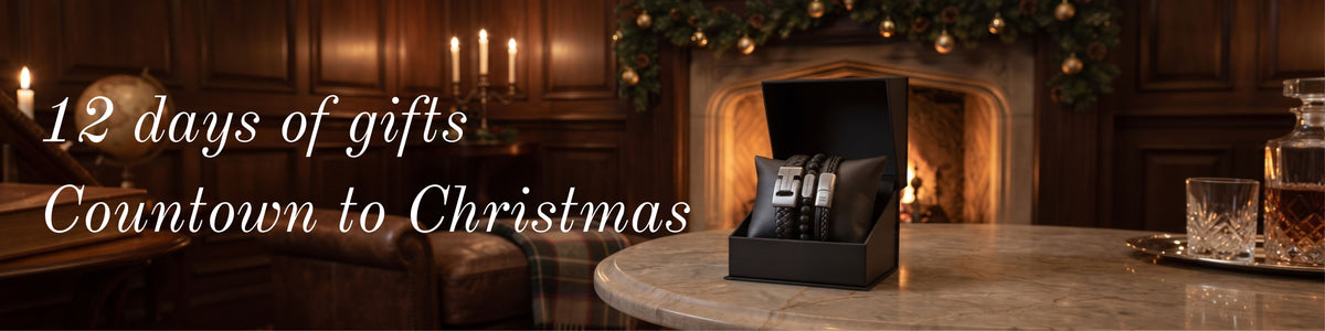 A black gift box on a marble table in a warm, dark wood living room setting, with a watch inside and large white text reading '12 days of gifts Countdown to Christmas'.