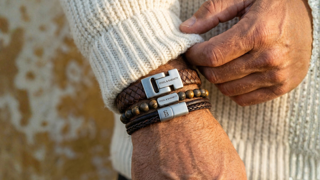 Stacked men's leather bracelet set in brown with braided and beaded styles and stainless steel clasps shown on wrist