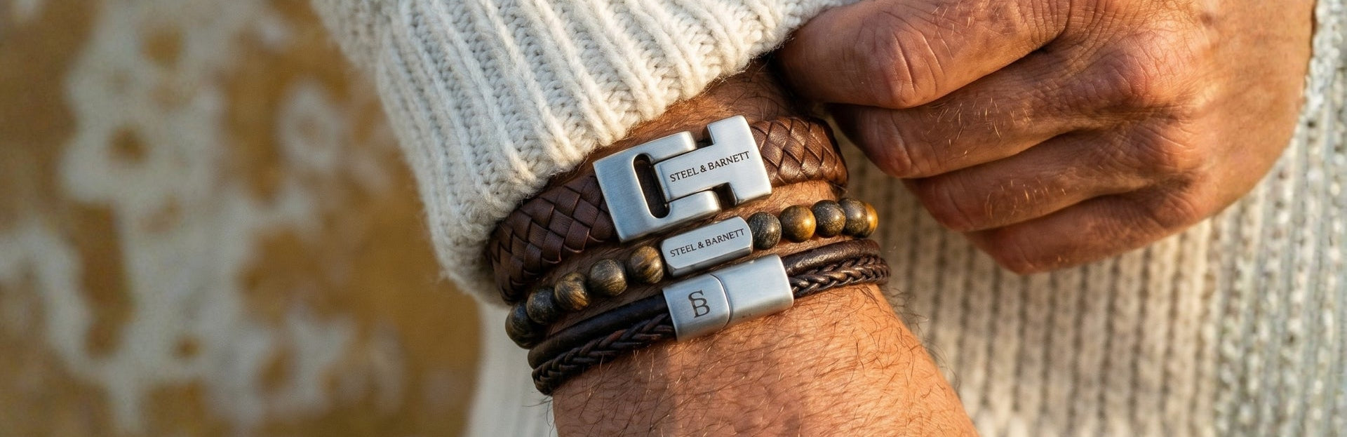 Stacked men's leather bracelet set in brown with braided and beaded styles and stainless steel clasps shown on wrist