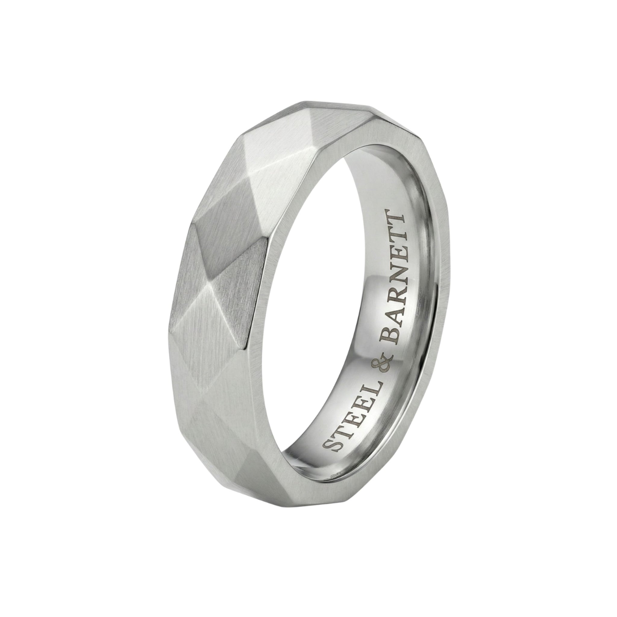 Silver stainless steel men's ring with a brushed faceted geometric design isolated on a white background