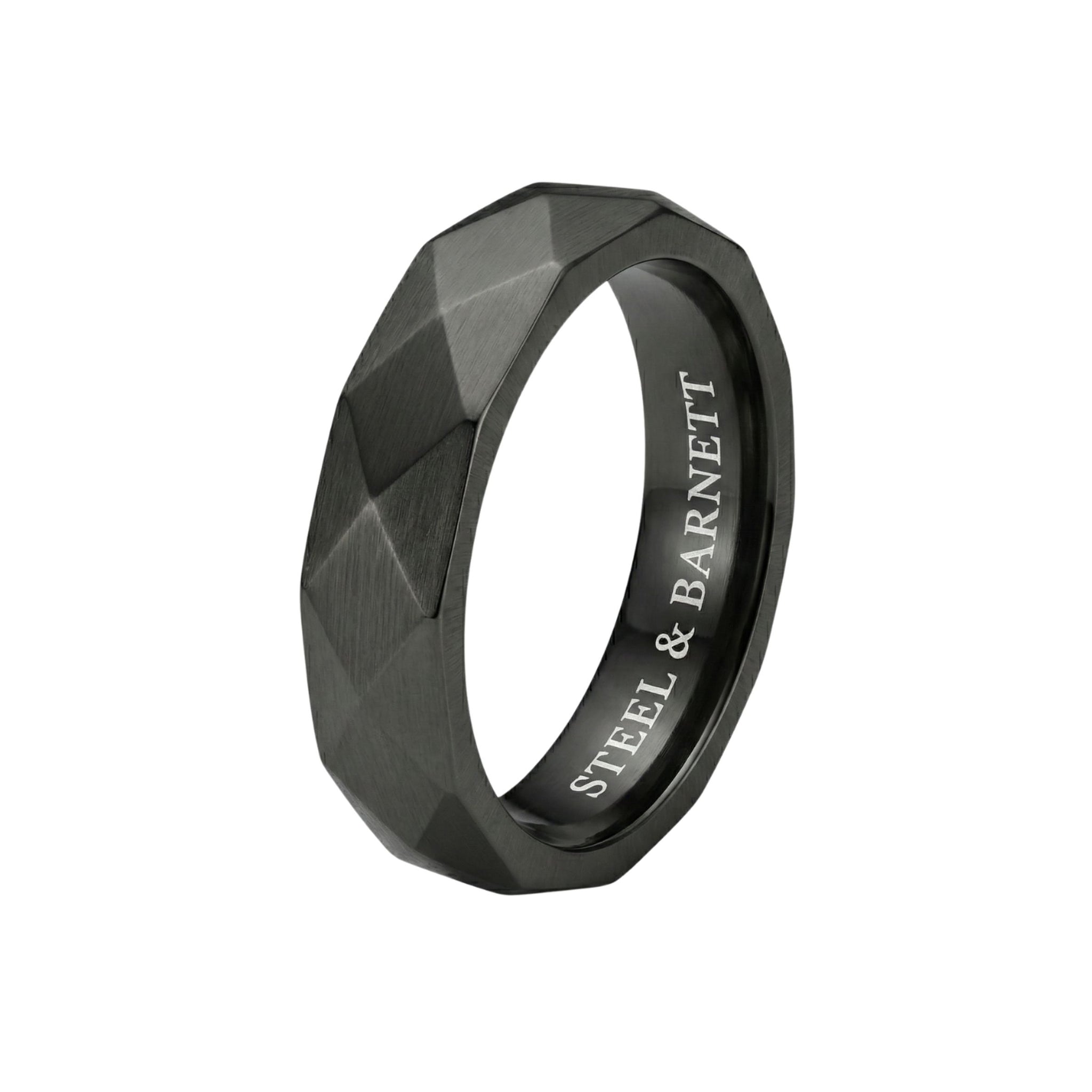 Black stainless steel men's ring with a brushed faceted geometric design isolated on a white background