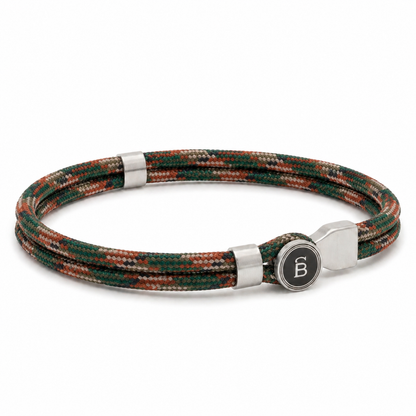 Green and brown patterned rope men’s bracelet with brushed stainless steel magnetic clasp and round logo detail on a white background