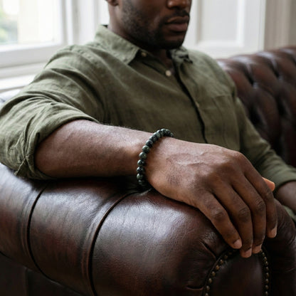 Green kambaba gemstone men’s bracelet with polished round natural stone beads worn on wrist in a lifestyle setting