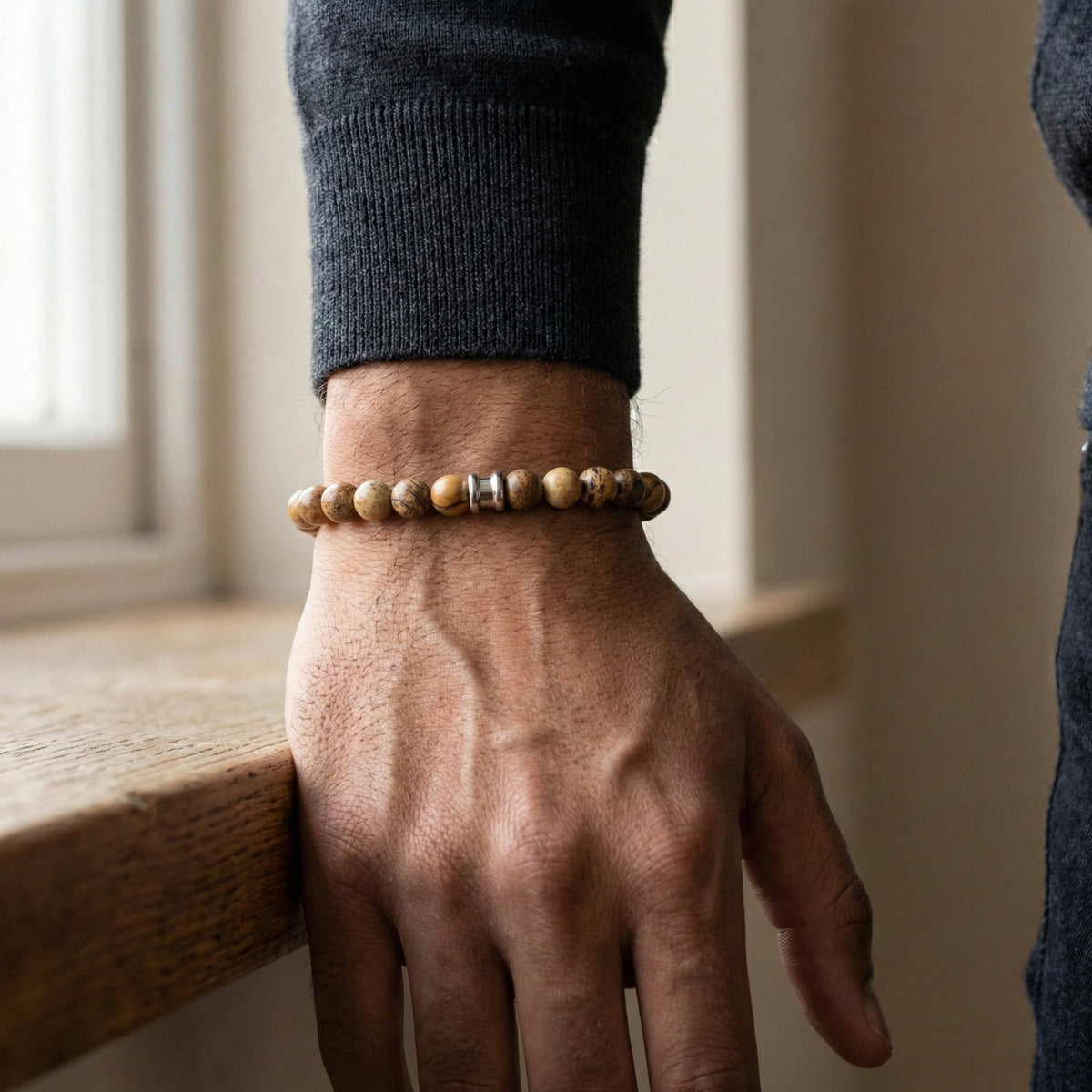 Beige and brown jasper men’s bracelet with matte round natural stone beads worn on wrist in a lifestyle setting