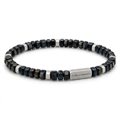 A beaded stretch bracelet featuring faceted dark blue and silver beads, with a polished silver clasp engraved with the brand name 'STEEL & BARNETT'.