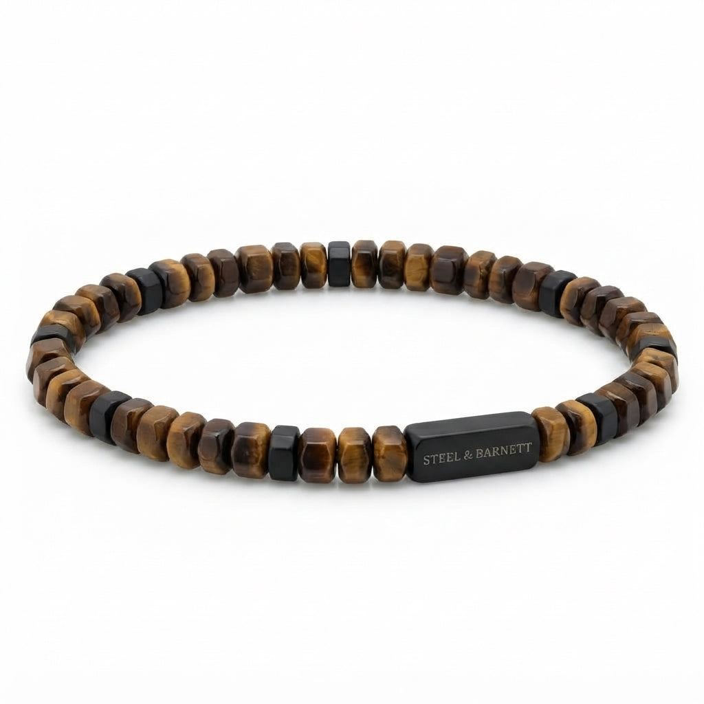 A beaded stretch bracelet featuring alternating brown and black tiger's eye beads, with a rectangular black metal clasp engraved with the brand name 'STEEL & BARNETT'.
