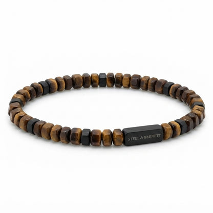 A beaded stretch bracelet featuring alternating brown and black tiger's eye beads, with a rectangular black metal clasp engraved with the brand name 'STEEL & BARNETT'.