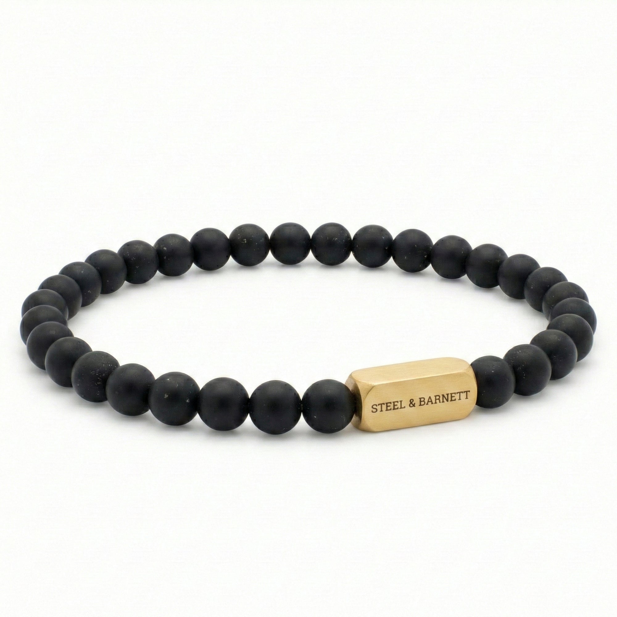 Black beaded men’s bracelet with matte round beads and plated 18K gold clasp on white background