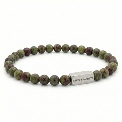 Dragon blood jasper men’s bracelet with green and red natural stone beads and brushed stainless steel bar on white background