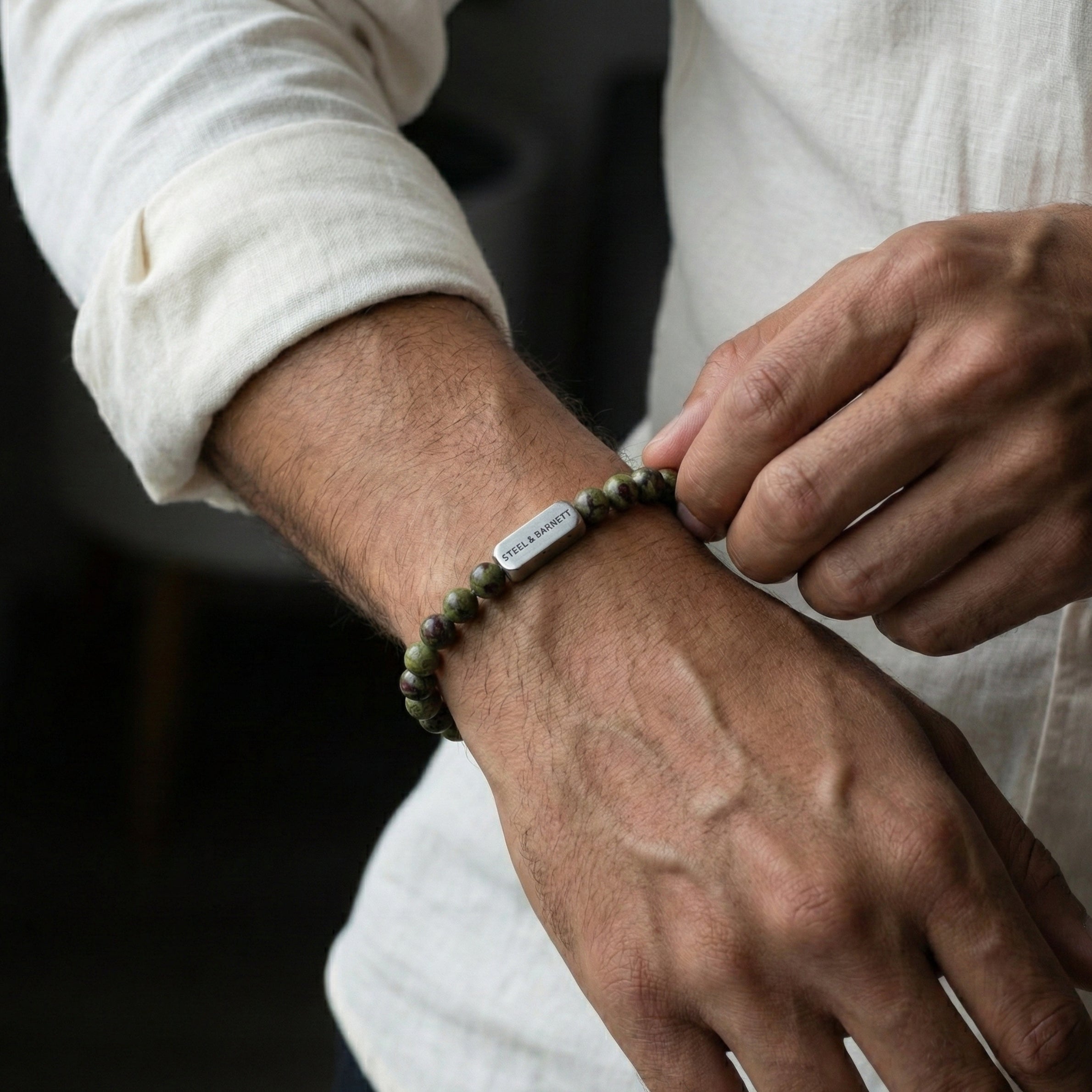 Dragon blood jasper men’s bracelet with green and red stone beads and brushed stainless steel bar worn on wrist