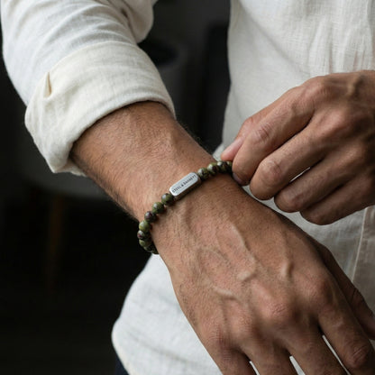 Dragon blood jasper men’s bracelet with green and red stone beads and brushed stainless steel bar worn on wrist
