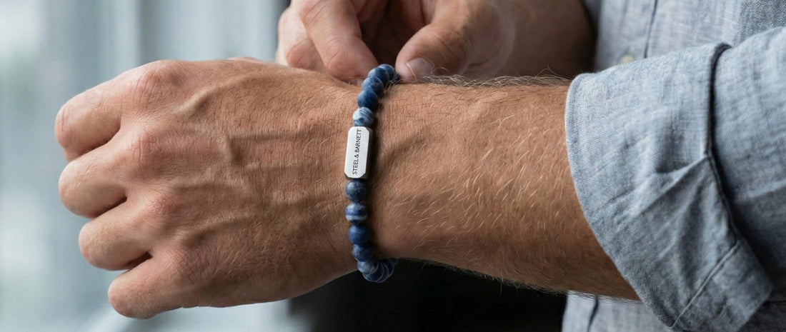 Person wearing a blue bracelet with a visible brand logo on a blurred background