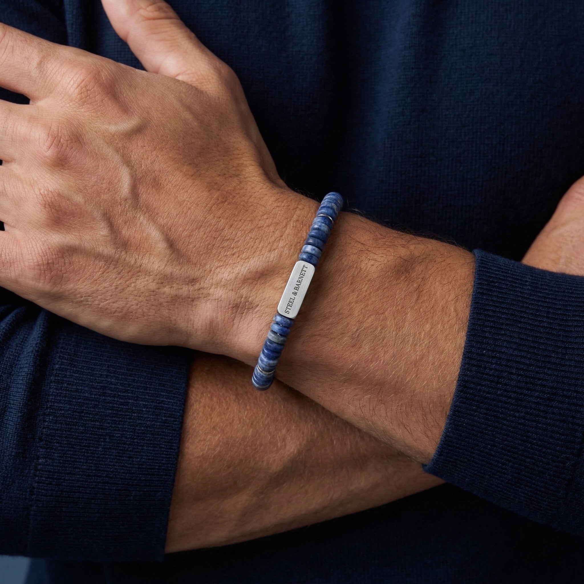 Blue natural stone men's beaded bracelet with brushed stainless steel accent plate worn on wrist