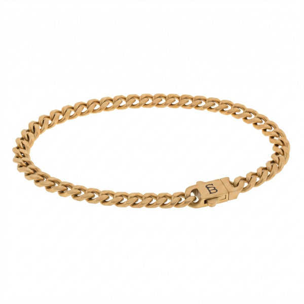 Gold toned stainless steel men’s bracelet with Cuban chain links and plated 18K gold clasp on white background