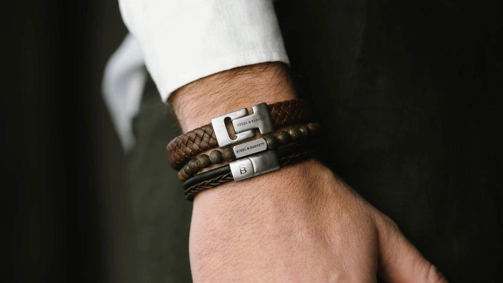 Steel & Barnett bestselling leather bracelets - Bonacci Brown, Harrison Black, and Harrison Blue worn stacked on wrist, showcasing magnetic stainless steel clasps and genuine Nappa leather.